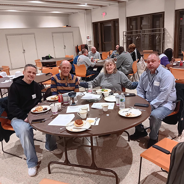 Men who worship with Breaking the Chains Church inside correctional centers in Wisconsin meet for dinner church