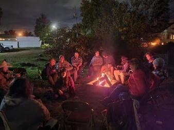 Group of people around a camp fire