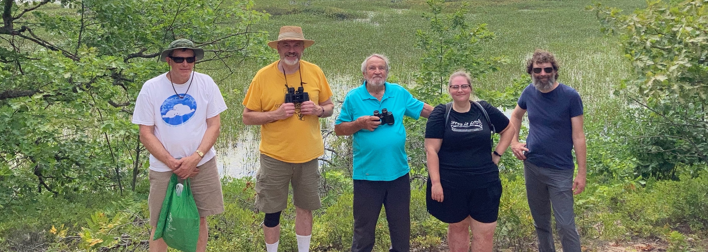 Group of people standing in a row in nature